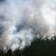 This aerial picture taken from an airplane on July 27, 2021, shows the smoke rising from a forest fire outside the village of Berdigestyakh, in the republic of Sakha, Siberia.